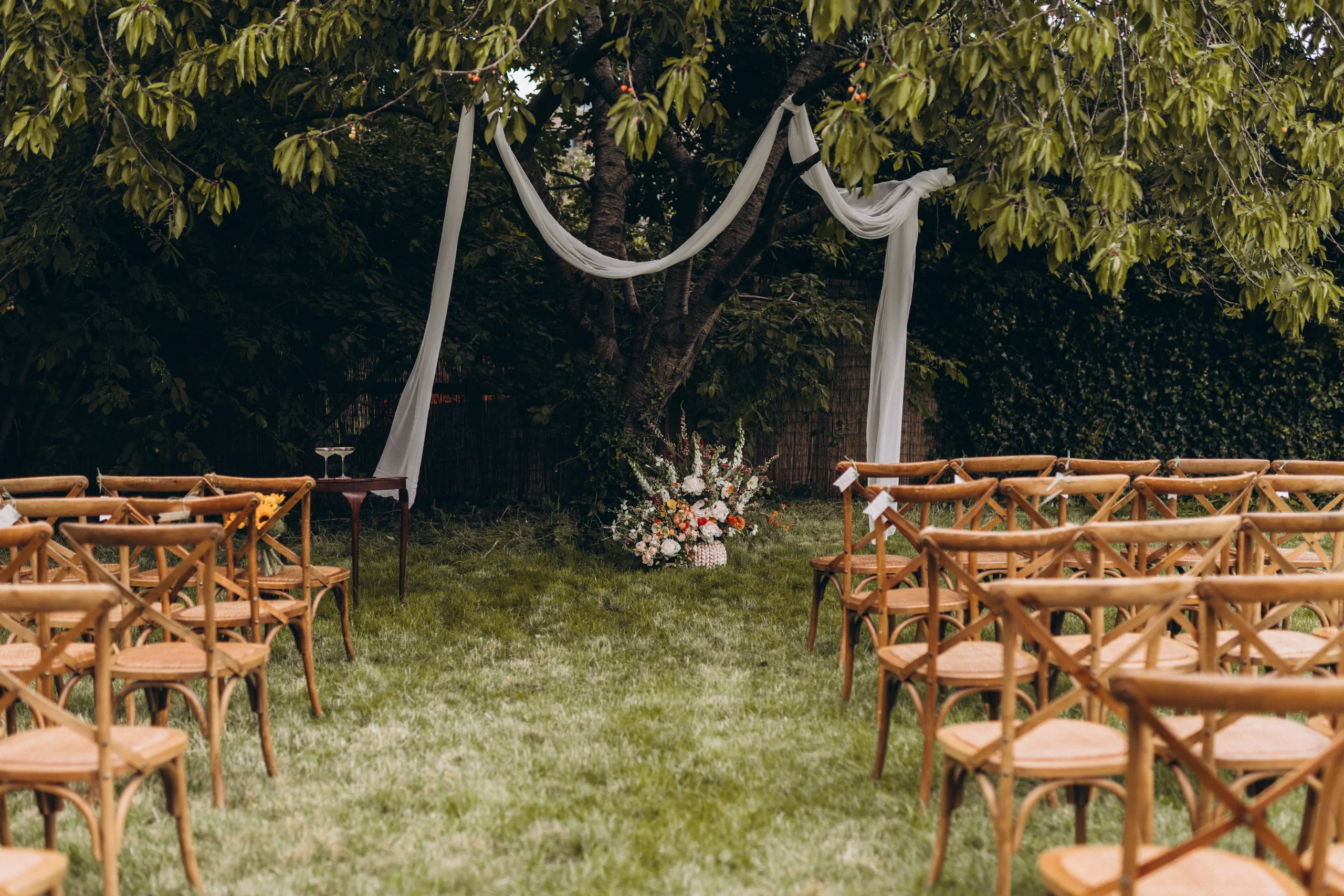 Lawn with wood chairs arranged for a wedding ceremony at Woodberry Wetlands