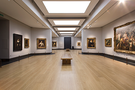 National Gallery room of Tudor paintings with blue-grey walls and dark grey trim.